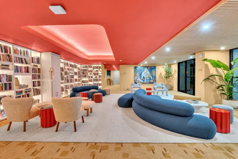 Library lounge with bookshelves and blue sofas