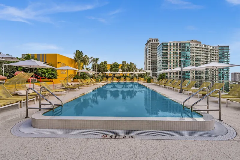 Rooftop pool lined with yellow loungers