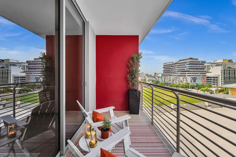 Balcony looking out over Midtown, with white lounge chairs and lanterns
