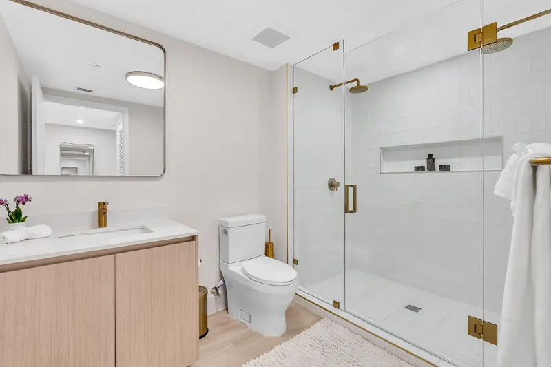 Bathroom with a glass walk-in shower and gold fixtures